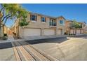 Tan two-story home with attached garage and balcony at 6255 W Arby Ave # 258, Las Vegas, NV 89118