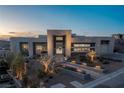 Modern home with sleek design, desert landscaping, and stunning curb appeal at 631 Cityview Ridge Dr, Henderson, NV 89012