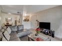 Open living area with gray sectional sofa and a view into the kitchen at 7885 W Flamingo Rd # 1037, Las Vegas, NV 89147