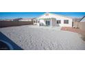 Spacious backyard with gravel, covered patio, and grill at 8145 Dancing Ave, Las Vegas, NV 89131