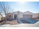 Single story home featuring a two-car garage and front yard at 8145 Dancing Ave, Las Vegas, NV 89131