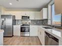 Contemporary kitchen featuring stainless steel appliances, sleek countertops, and gray subway tile backsplash at 8255 Las Vegas Blvd # 611, Las Vegas, NV 89123