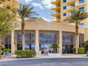 Bright and airy lobby entrance featuring modern architecture with palm trees in front of the building at 8255 Las Vegas Blvd # 611, Las Vegas, NV 89123