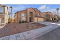 Two-story house with a three-car garage and desert landscaping at 8501 Vivid Violet Ave, Las Vegas, NV 89143