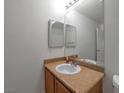 Bathroom with single sink vanity, granite countertop, and a mirror at 8600 W Charleston Blvd # 1034, Las Vegas, NV 89117