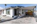 Front view of a remodeled home with a covered patio and gated side yard at 909 Hassett Ave, Las Vegas, NV 89104