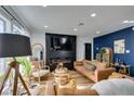 Bright living room with hardwood floors, fireplace, and leather couches at 909 Hassett Ave, Las Vegas, NV 89104