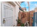 Front door entrance with decorative metal gate and landscaping at 932 Angel Star Ln, Las Vegas, NV 89145