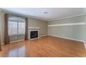 Living room with hardwood floors, fireplace and large window at 932 Angel Star Ln, Las Vegas, NV 89145