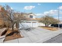 Two-story home featuring a concrete driveway and an attached two-car garage at 9916 Sierra Canyon Way, Las Vegas, NV 89147