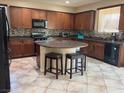 Spacious kitchen with large island and dark wood cabinets at 1136 Buckhorn Cove St, Henderson, NV 89011