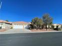 Single-story house with three-car garage and desert landscaping at , Las Vegas, NV 89123