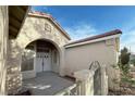 Inviting home entrance with double doors, arched entryway, and beautiful architectural details at , Las Vegas, NV 89123