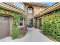 Elegant entryway with double doors and lush greenery at 10213 Owls Peak Ct, Las Vegas, NV 89144