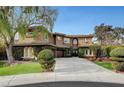 Two-story home with a manicured lawn and driveway at 10213 Owls Peak Ct, Las Vegas, NV 89144