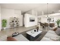 Virtually staged living room with dining area and large windows at 1036 Aspen Daisy Ave, Henderson, NV 89074