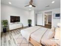 Virtually staged main bedroom with a light wood platform bed and walk-in closet at 10425 Seelos St, Las Vegas, NV 89178