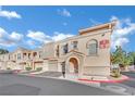 Exterior view of a townhome complex featuring a well-manicured landscape and architecturally interesting design at 10550 W Alexander Rd # 1007, Las Vegas, NV 89129