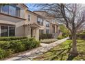 Charming townhome with well-maintained landscaping and a sidewalk at 11518 Belmont Lake Dr # 104, Las Vegas, NV 89135