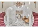 Elegant foyer with marble floors, a grand staircase, and a luxurious chandelier at 1245 S Rancho Dr, Las Vegas, NV 89102