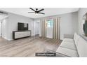 Comfortable living room featuring a neutral sofa, modern media console, ceiling fan, and stylish decor at 139 Ivy St, Henderson, NV 89015