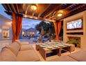 Covered patio with seating, dining, and a TV, perfect for entertaining at 2200 Nordica Ct, Las Vegas, NV 89117