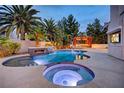 Luxury pool and spa with a fire feature and outdoor entertainment area at 2200 Nordica Ct, Las Vegas, NV 89117