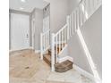 Entryway with stone floors, white trim, neutral walls, and a staircase leading to the upper level at 25 Via Mantova # 2, Henderson, NV 89011