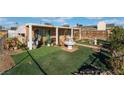 Landscaped front yard features green grass with rock lined borders, a fountain, and desert plants at 3327 Rio Grande St, Las Vegas, NV 89115