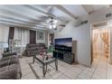 The cozy living room features beamed ceilings, tile floors, and neutral paint at 3327 Rio Grande St, Las Vegas, NV 89115