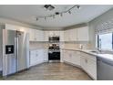 Bright kitchen with stainless steel appliances, white cabinetry, and modern countertops at 3663 Laguna Verde Way, Las Vegas, NV 89121