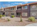 Two-story condo building with balconies, desert landscaping and a red tile roof offers a low-maintenance lifestyle at 5046 S Rainbow Blvd # 103, Las Vegas, NV 89118