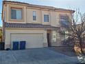 Two-story house with attached garage and landscaping at 5325 Big Fawn Ct, Las Vegas, NV 89130