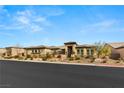 Single-story home with a neutral color palette and landscaping at 5860 Noah Springs Ct, Las Vegas, NV 89149