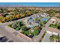 Aerial view showcasing house, expansive yard, tennis court, and mountain views at 5880 W Oquendo Rd, Las Vegas, NV 89118