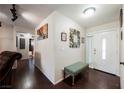 Home entryway with wood-look flooring, a bench, and framed wall art at 6232 Lanning Ln, Las Vegas, NV 89108