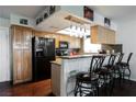 Kitchen with light wood cabinets, granite countertops, and black appliances at 6232 Lanning Ln, Las Vegas, NV 89108