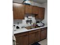 Functional kitchen with wood cabinets and double sink at 6256 Dayton Ave, Las Vegas, NV 89107