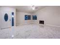 Bright living room with marble floors, fireplace, and high ceilings at 6584 Banbridge Dr, Las Vegas, NV 89103