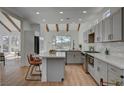 Stylish kitchen features an island with seating, marble countertops, and stainless steel appliances at 8941 Diamond Falls Dr, Las Vegas, NV 89117