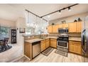 Well-lit kitchen with stainless steel appliances, granite countertops, and modern lighting fixtures at 904 Domnus Ln # 201, Las Vegas, NV 89144