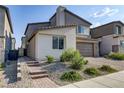 Two-story home with light-colored siding and brick accents at 9281 Albus Hills Ave, Las Vegas, NV 89143