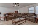 Spacious living room featuring a large sectional sofa and coffee table at 9290 Cool Creek Ave, Las Vegas, NV 89147