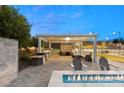 Outdoor kitchen, seating area, and fire pit at 1121 Du Fort Hills Ct, Henderson, NV 89002