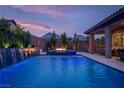 Inviting pool and spa with a fire pit and mountain views at 11885 Grassy Plain Ave, Las Vegas, NV 89138