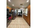 Well-lit kitchen featuring stainless steel appliances and tile flooring throughout with eating area at 1737 W Nelson Ave, North Las Vegas, NV 89032