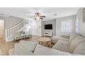 Spacious living room featuring L-shaped sofa and wood-look floors at 1903 Sundown Canyon Dr, Henderson, NV 89014