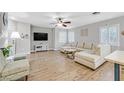 Open living area with L-shaped sectional and wood floors at 1903 Sundown Canyon Dr, Henderson, NV 89014