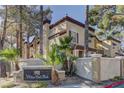 Condominium complex with desert landscaping, block wall and sign reading 