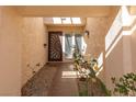 Inviting entryway with a decorative door and plants at 3126 Cabachon Ave, Las Vegas, NV 89121